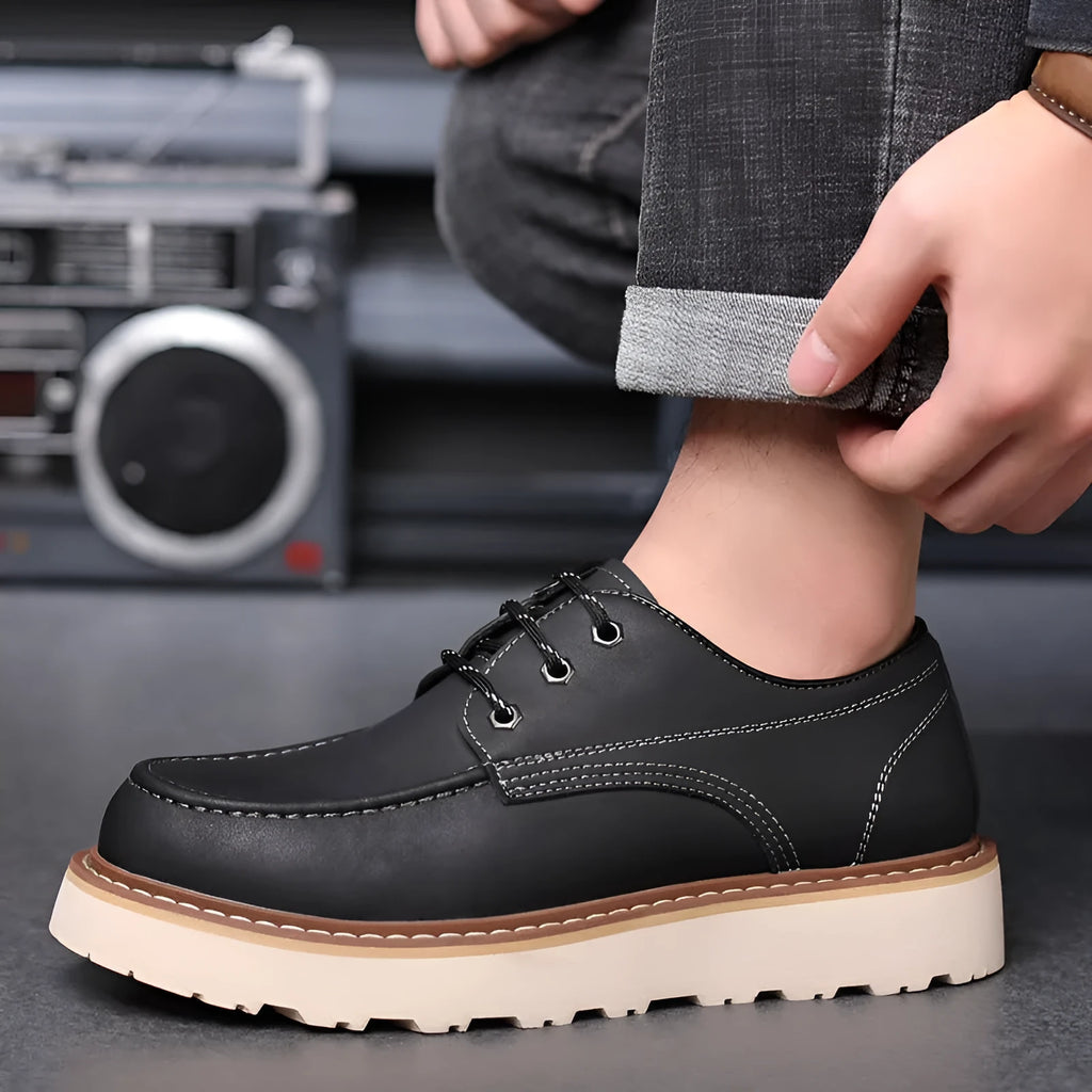 Men's black low top Martin boots with round toe and non-slip rubber sole on a neutral background.