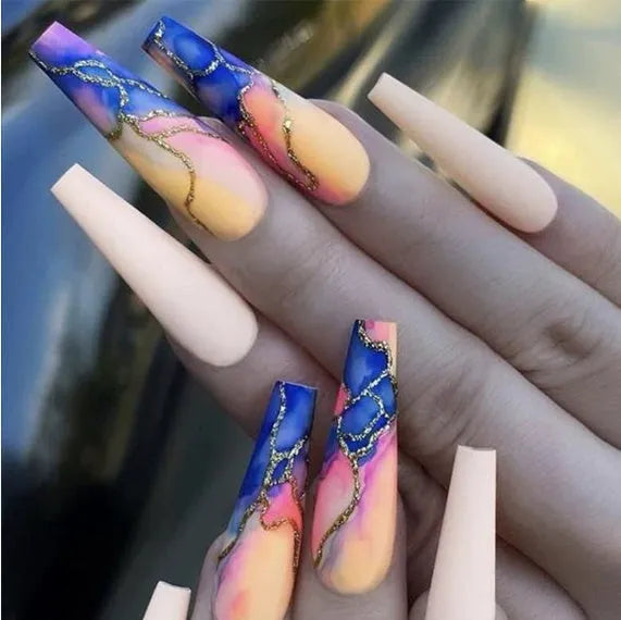 Close-up of finished W067 wave line design nail stickers with jelly glue tube on a manicured hand.
