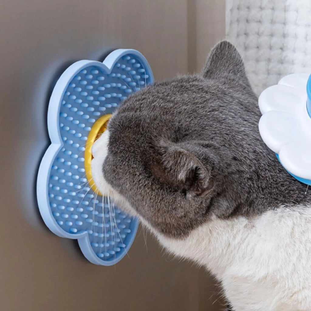 Flower-shaped blue silicone pet lick mat with suction cups on a tiled floor.