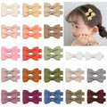 Forty pastel coloured hair clips for babies arranged by colour with fully lined no-slip design
