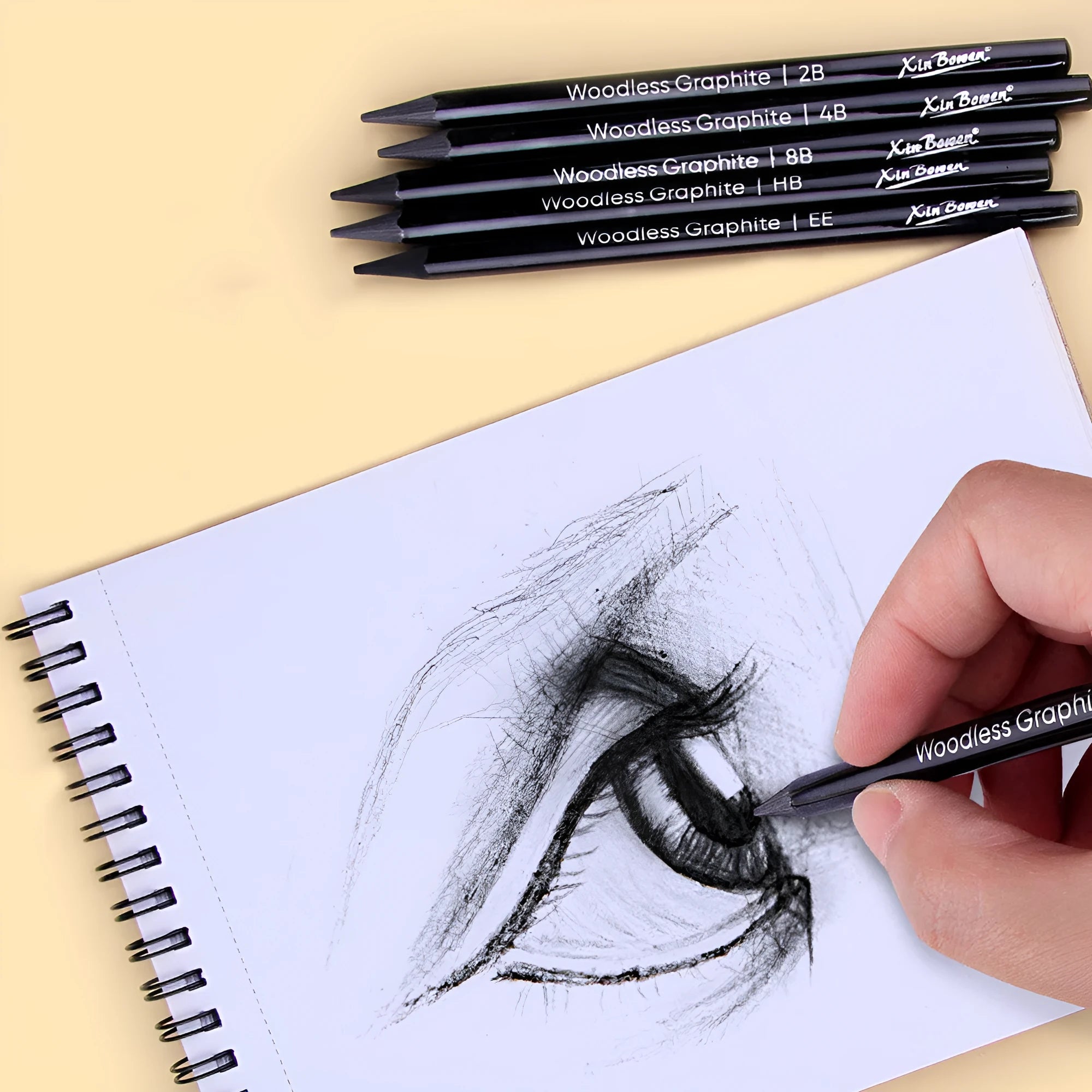 Six graphite sketching pencils with HB, 2B, 4B, 6B, 8B, and EE grades arranged in art set