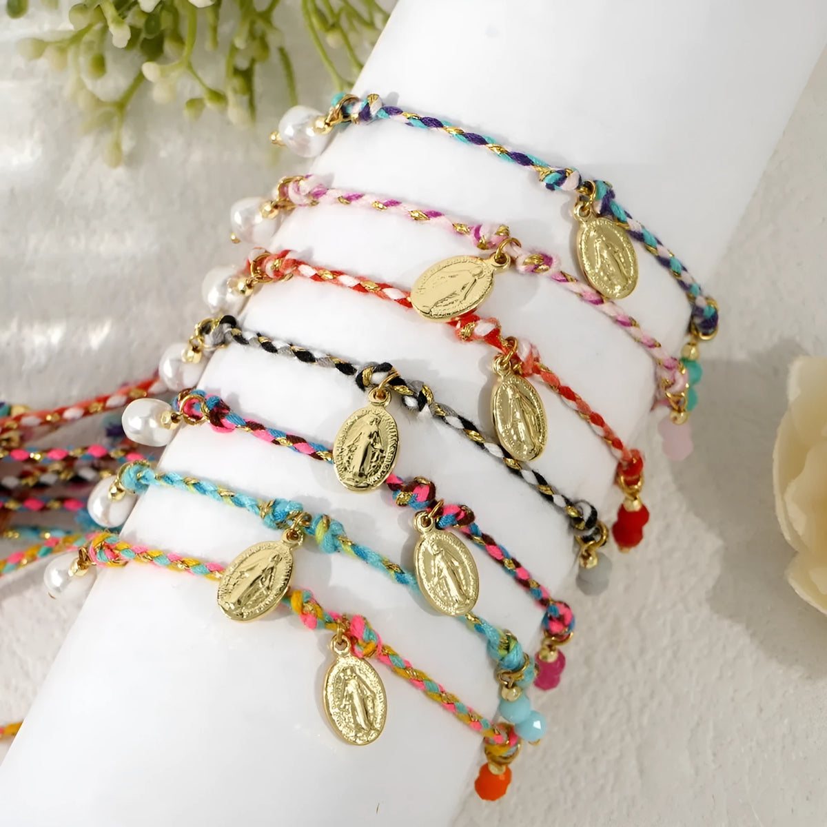 Women's adjustable woven bracelet made from colourful braided rope with a strap tag.
