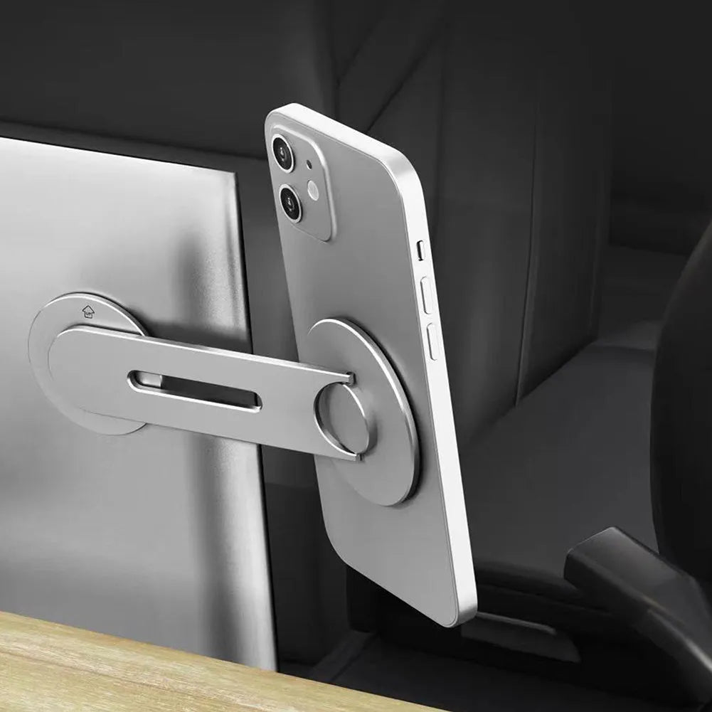 Silver magnetic car phone holder with 180-degree rotation on dashboard