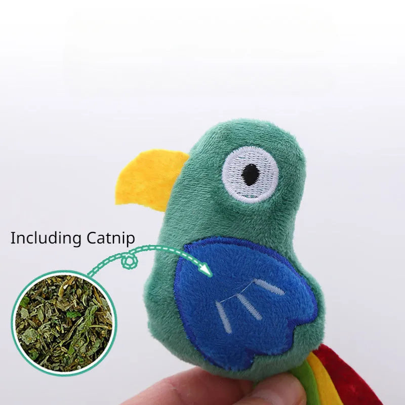Plush cat toy in shape of a cow, a crocodile, and a parrot on a plain background.