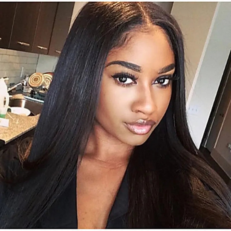 Long straight black synthetic wig on a mannequin head, featuring a centre parting and straight-cut bangs.