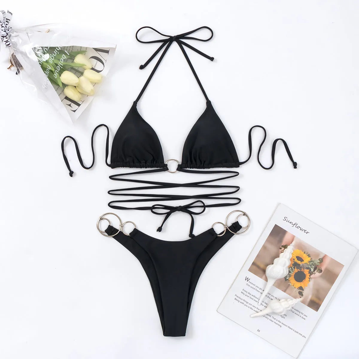 Black women's bikini set with metal ring straps and high-cut split briefs.