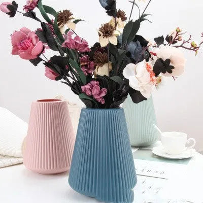 Melamine plastic decorative flower vase in four colours on desktop