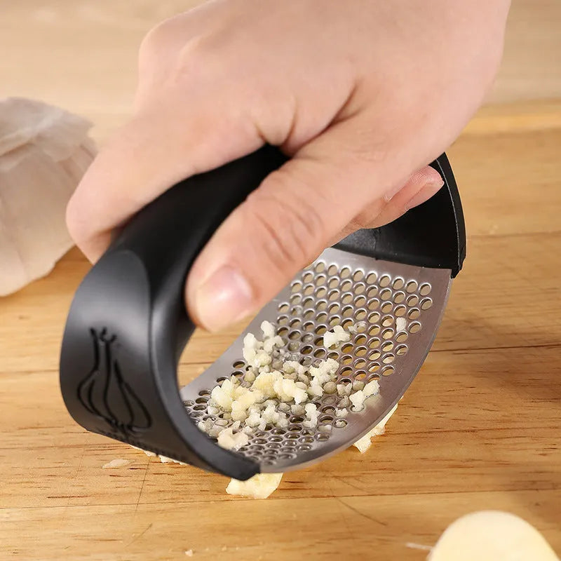 304 stainless steel garlic press in green, pink, black, or blue colour measuring 11x7cm