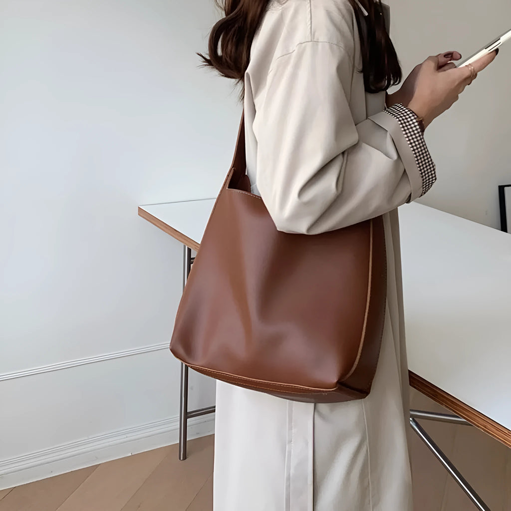 Women's soft PU shoulder bag with swing thread detail in black or brown colour