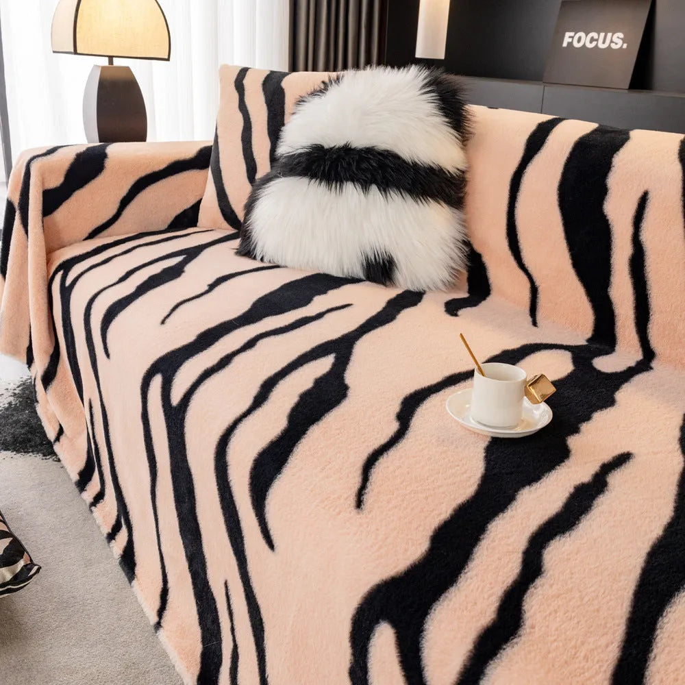 Zebra pattern flannel sofa cover and pillowcase set on a sofa, shown in caramel colour.