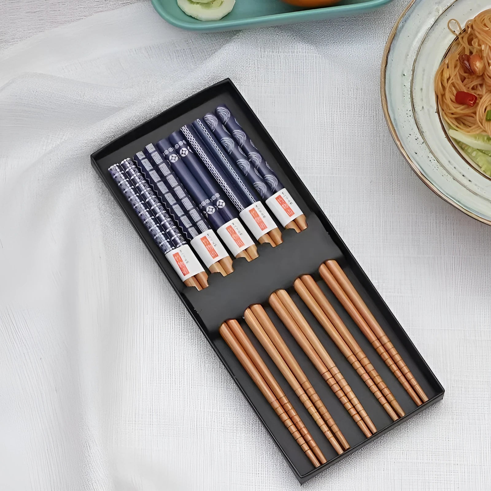 Set of five Japanese style patterned bamboo chopsticks showing lucky cat and pool elegant blue cartoon designs.