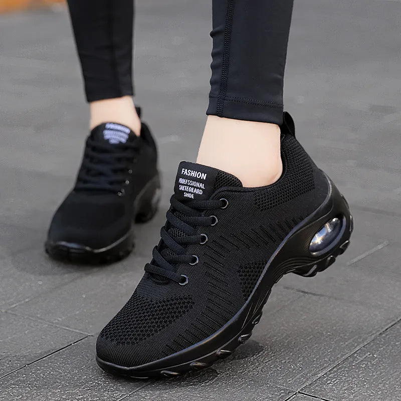 Women's red mesh sneakers with round toe and front lace-up design on flat heel