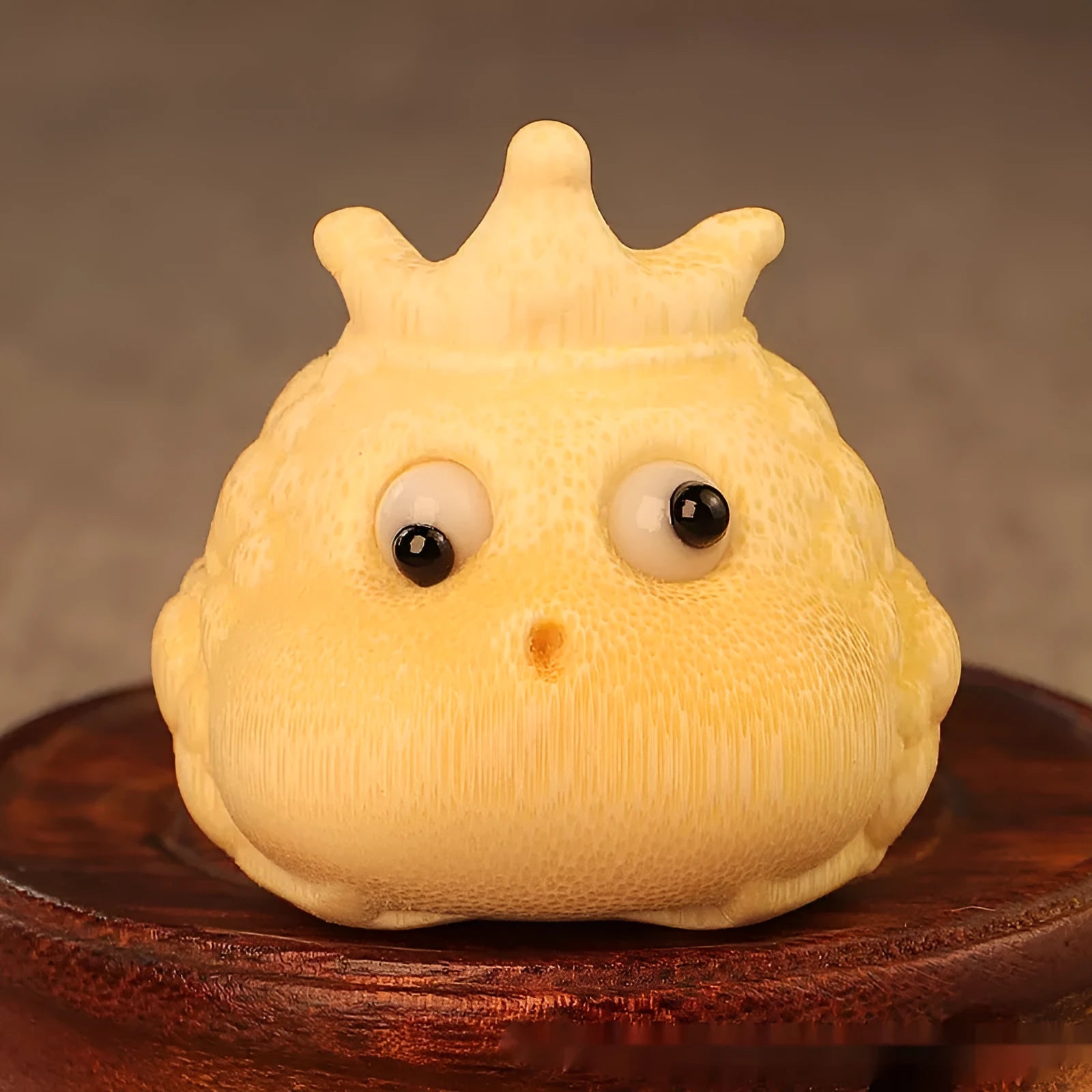 Solid bamboo Crown Princess Toad carving ornament in cute style on a plain background.