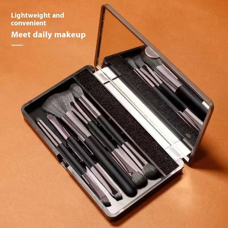 Makeup brush set with mirror case showing silver and gold brush options with artificial fibre hairs