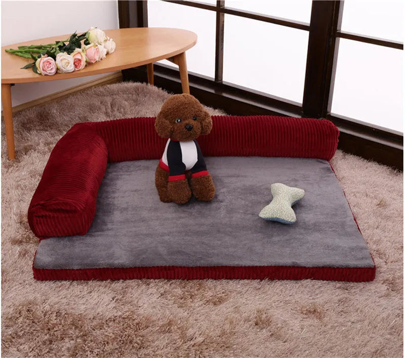 Grey corduroy dog sofa bed with bilateral bolsters on a wooden floor.