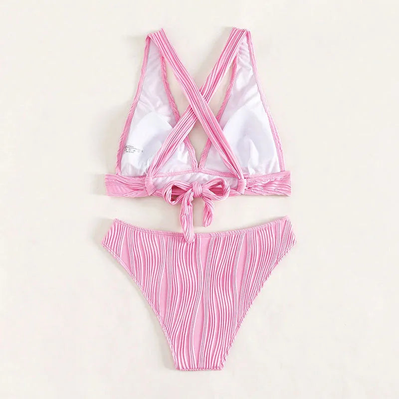 Women's black and pink halter neck bikini set with matching shorts on a mannequin.