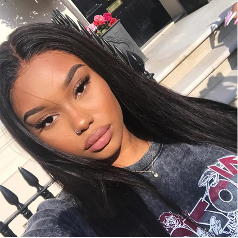Long straight black synthetic wig on a mannequin head, featuring a centre parting and straight-cut bangs.