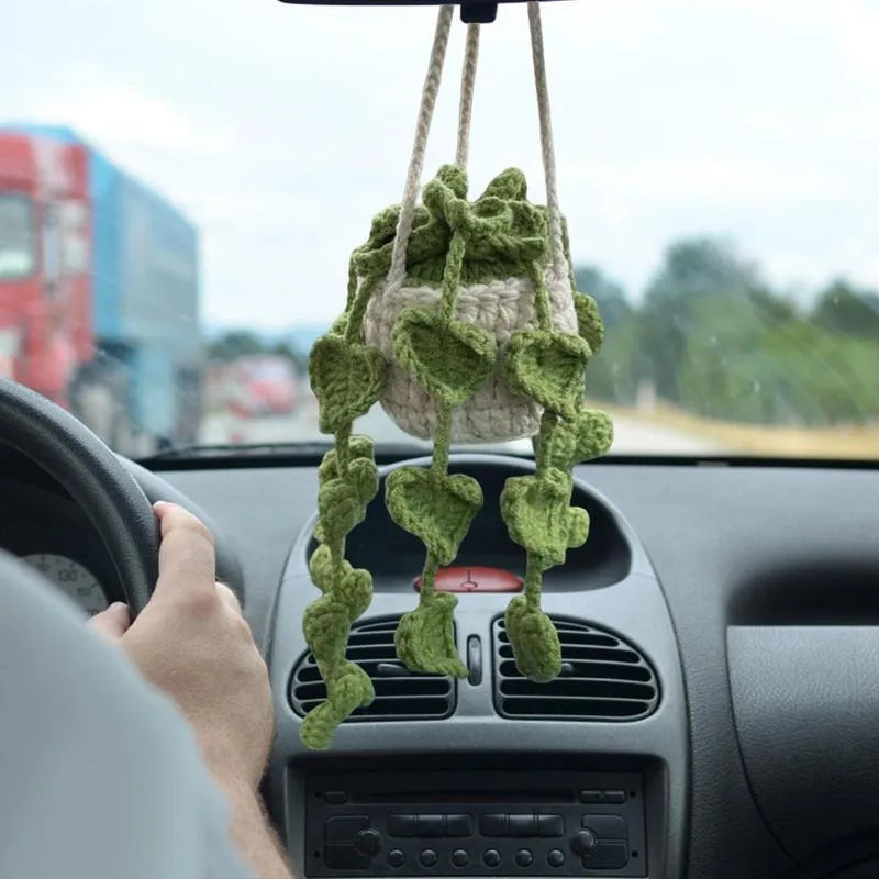 Green and white knitted car plant ornament with basin base and hanging rope