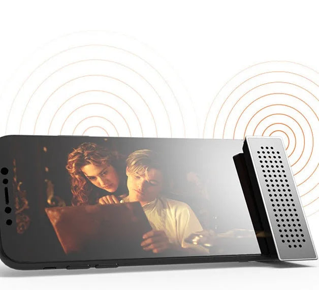 A portable black ABS mobile phone amplifier bracket holding an iPhone to boost sound for desktop use.