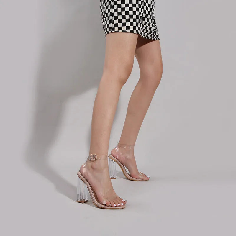 Apricot coloured women's transparent PVC high heel sandals with buckle fastening and glass heel.