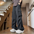 Plus size women's thin waterproof trousers in grey with a drawstring waist and straight leg.