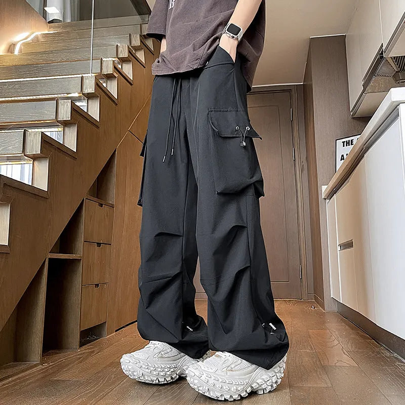 Plus size women's thin waterproof trousers in grey with a drawstring waist and straight leg.