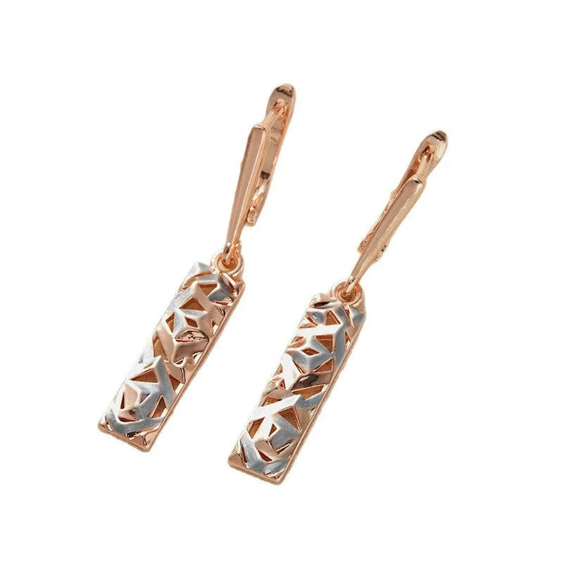 A pair of rectangular two-tone hollow stud earrings with an electroplated finish on a white background.