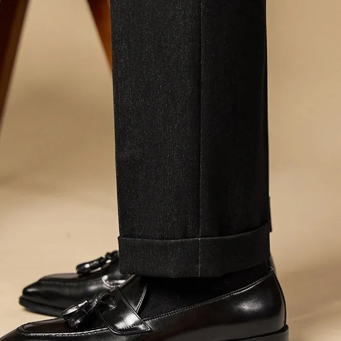 British-style leather tassel loafers in polished black leather with rubber sole