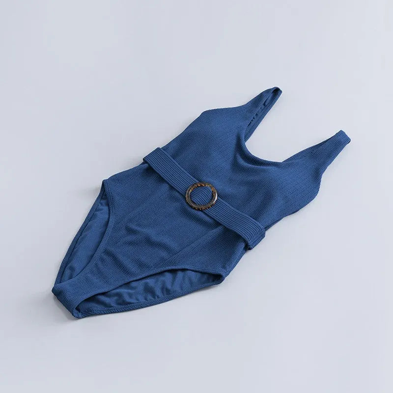 Navy blue women's one-piece swimsuit with triangle design and chest pads