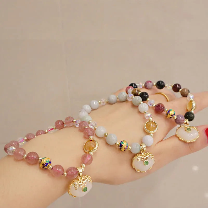 Women's ethnic bracelet with geometric metal decorations and strawberry quartz or gray jade beads