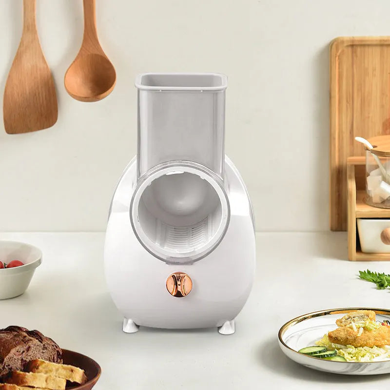 White electric vegetable slicer with three blade pairs and strong suction base for kitchen use
