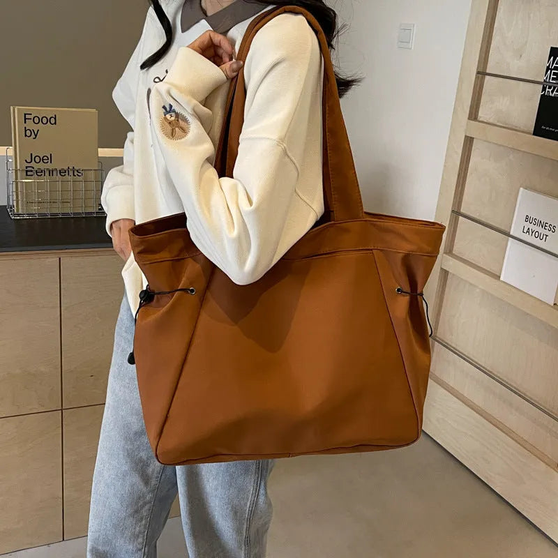 Soft Oxford cloth foldable tote bag in street style, shown in available colours.
