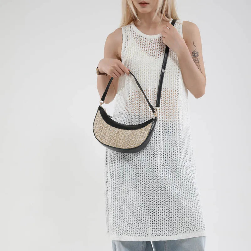 Hard straw women's crossbody dumpling bag in black with contrast stitching and interior compartments