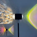 Modern sunset red floor lamp projecting a water ripple pattern on a wall.