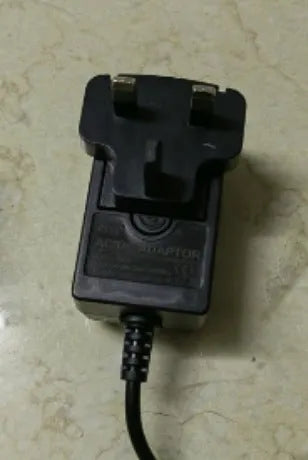 Charging hair clippers with stainless steel cutter head showing EU UK US plug options