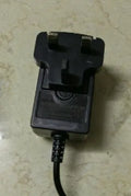 Charging hair clippers with stainless steel cutter head showing EU UK US plug options