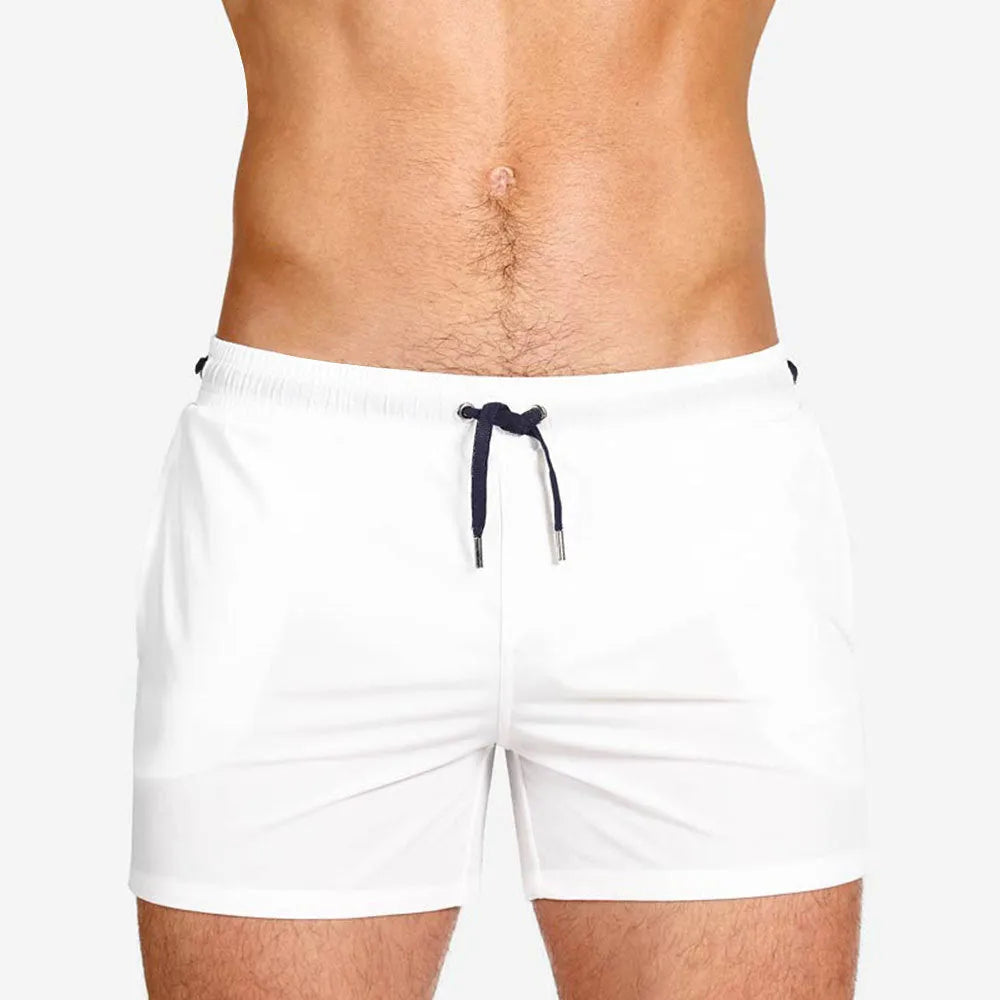 Men's solid colour polyester swimming shorts with mesh lining for sports and fitness.