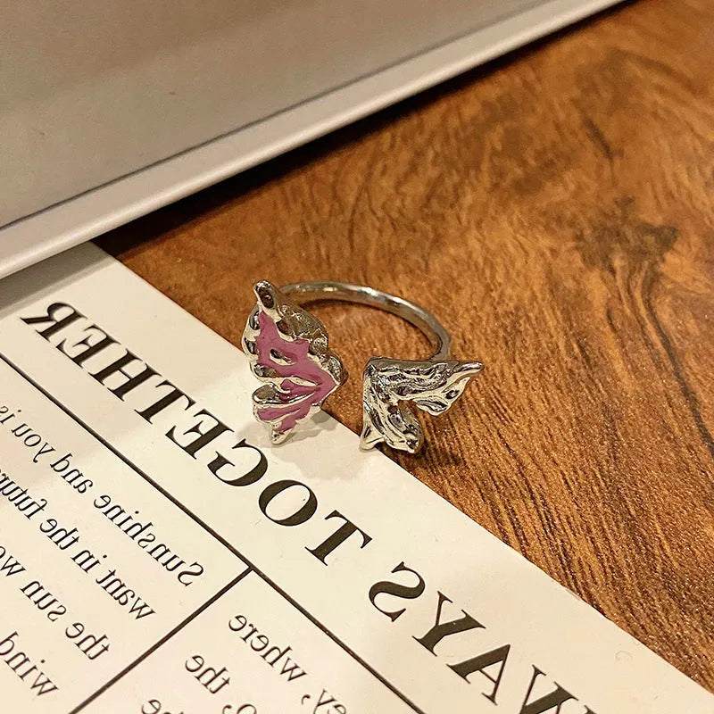 Copper butterfly women's ring with drip oil finish in an open-loop design.