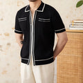 Slim-fitting black short-sleeved polo shirt with a lapel collar, made from a knitted viscose and polyester fabric blend.