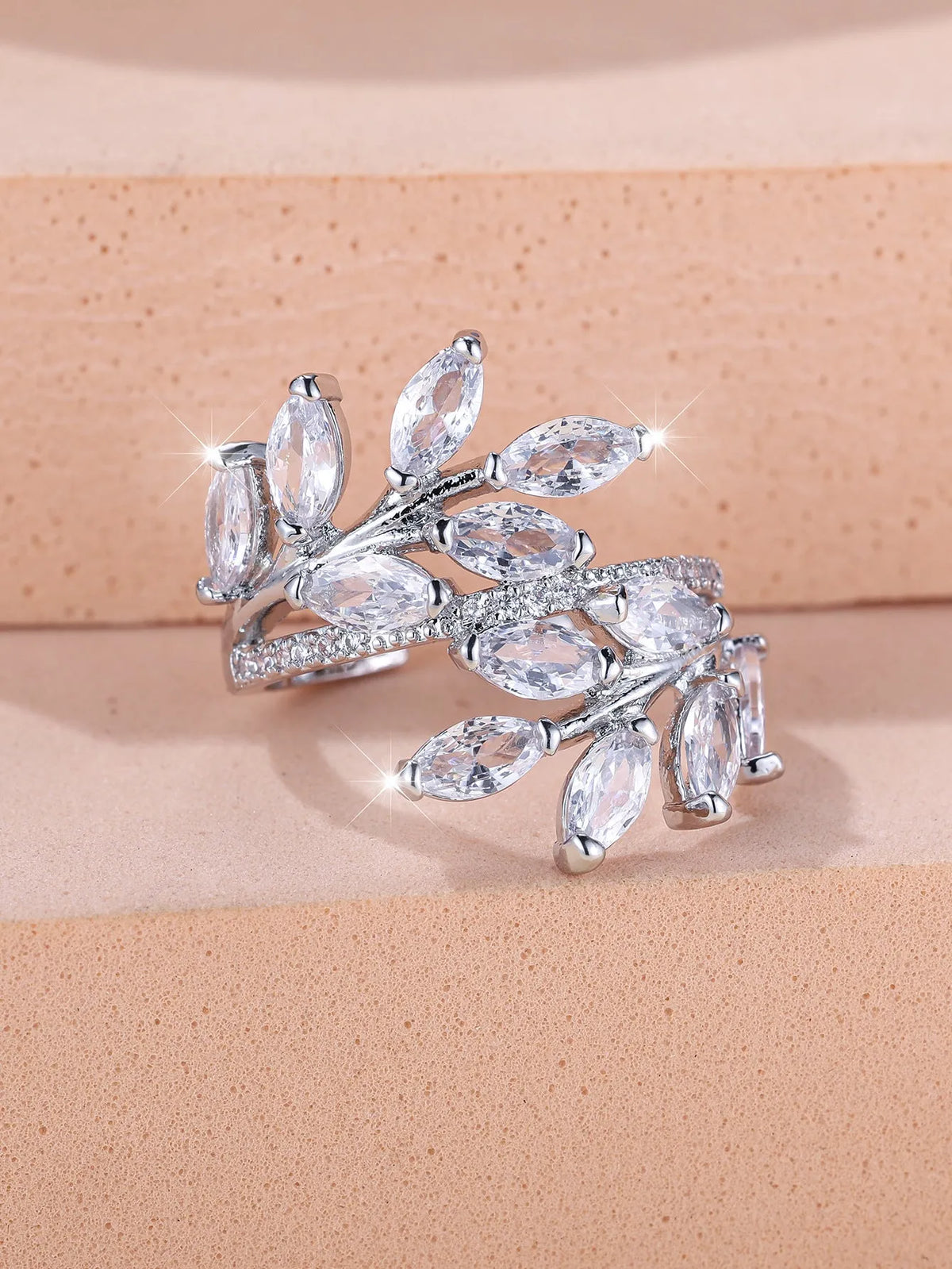 Adjustable copper leaf ring with zircon detailing in multiple colour options on display