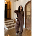 Brown women's loose fit casual sports suit set with long sleeve top and trousers on a model.