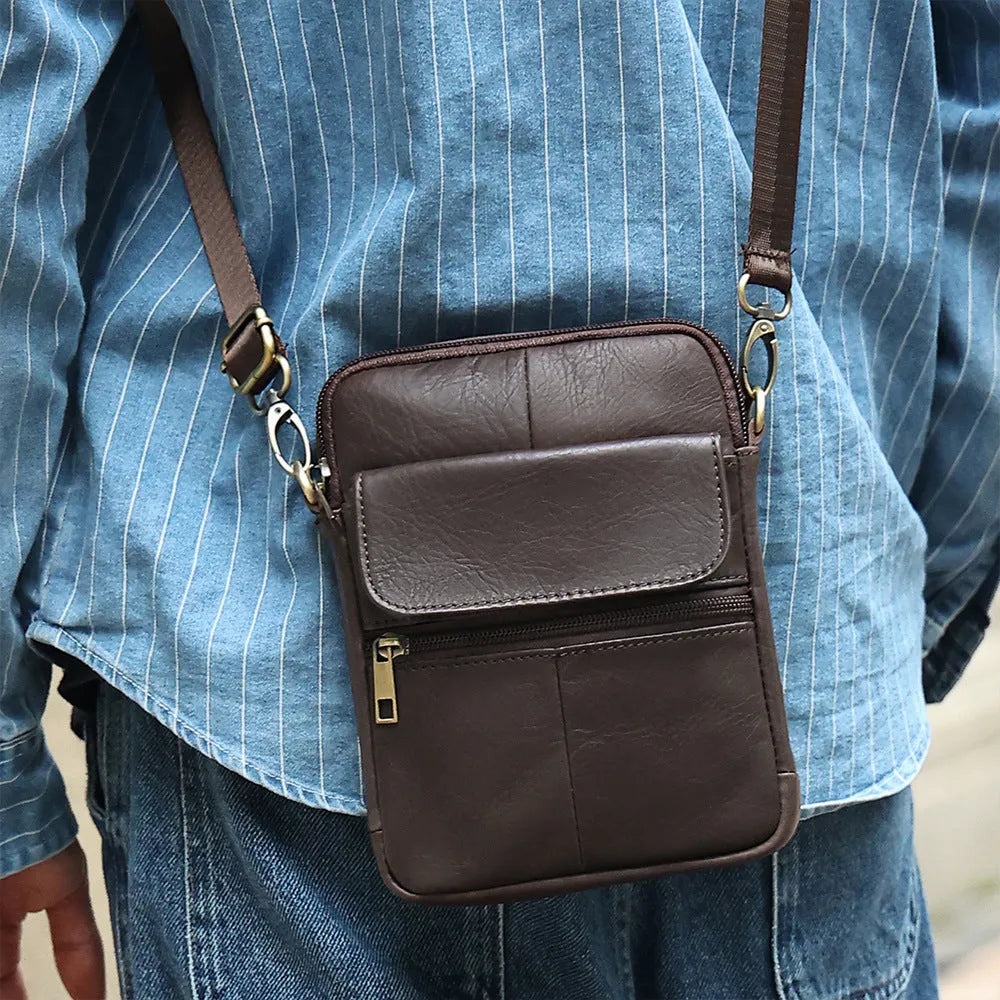 Men's brown genuine leather crossbody shoulder bag with sewn detailing and a shoulder strap.