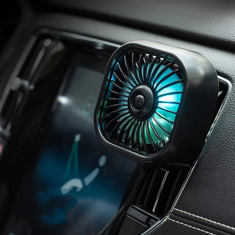 Compact black USB car fan with three speed buttons on dashboard