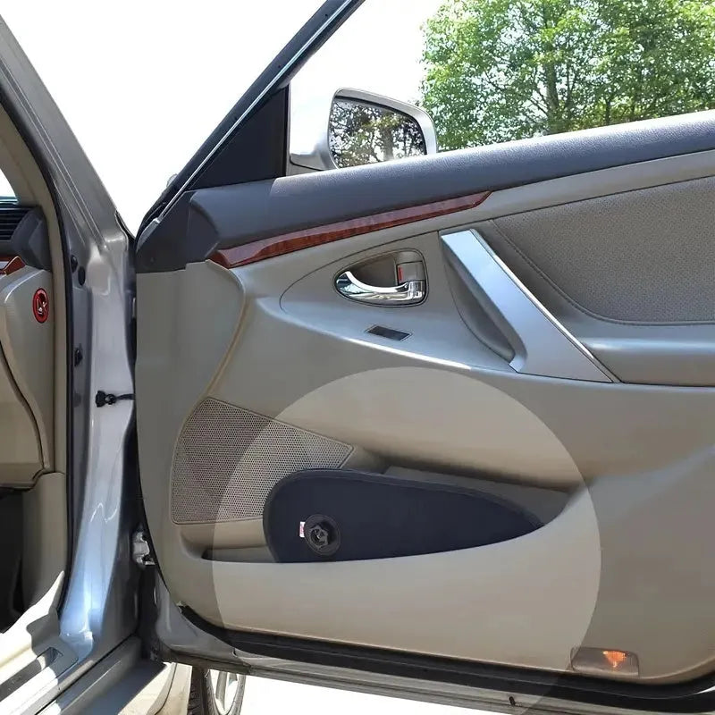 Black stretchy car window shade with suction cups attached to a side window.