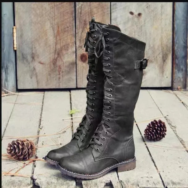 Women's black chunky low heel high leg ankle boots made from artificial PU leather.