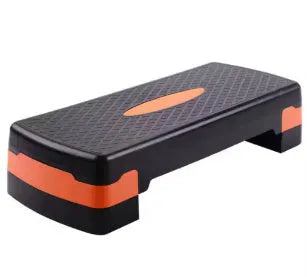 Grey fit step aerobics platform made of ABS plastic on a wooden floor.