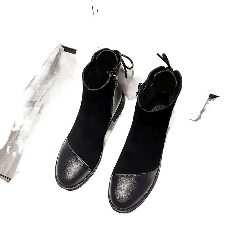Black women's knee boots with side zip, round toe, short heel and decorative bow.