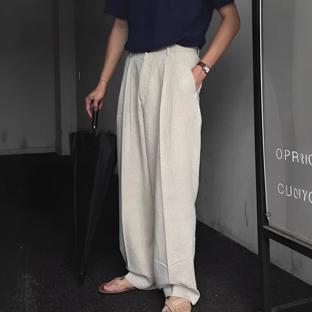 Men's apricot coloured loose-fit cotton linen trousers with a pencil leg on a plain background