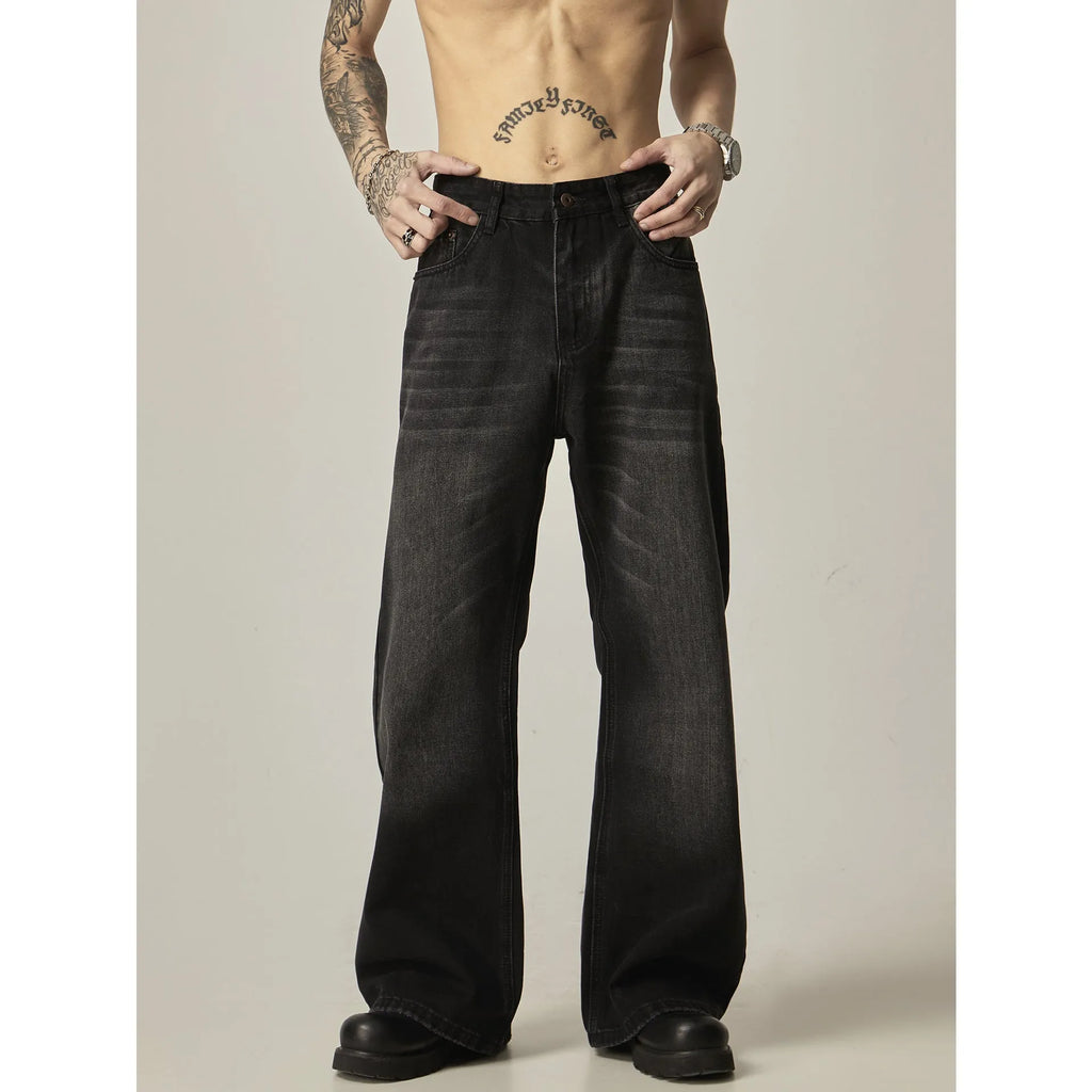 Black loose-fit straight-leg retro jeans with a zipper fly on a mannequin.