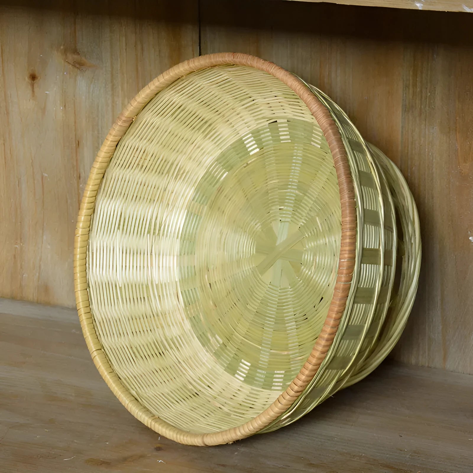 Handmade woven natural bamboo storage basket shown in one of three size options.